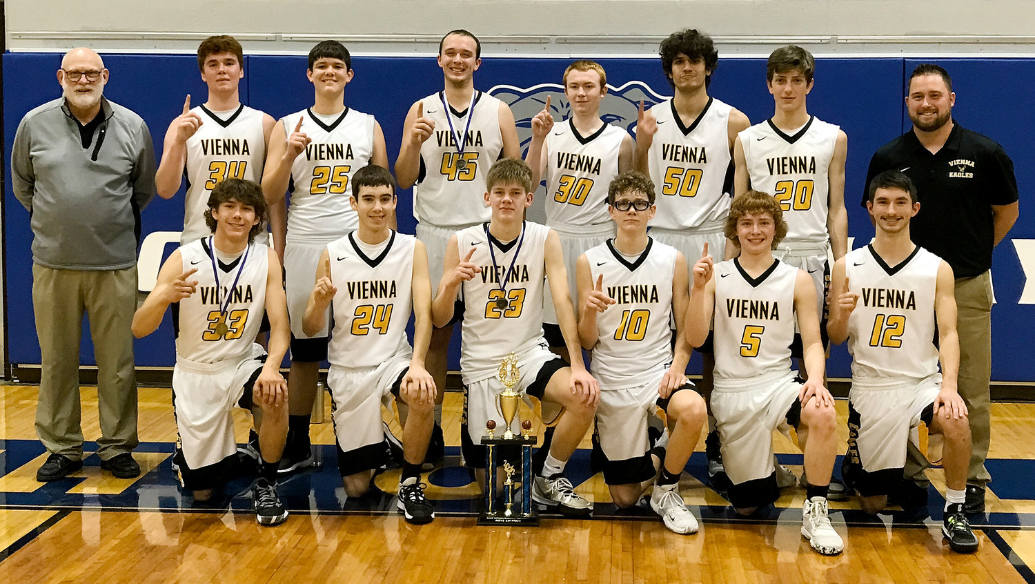 Vienna Eagle basketball team members celebrate their tournament championship Friday night at South Callaway following a 58-48 come-from-behind victory over Hermann’s Bearcats. This marked Vienna’s first tournament title since winning the Calvary Lutheran Tournament back in January of 2018. Team members (above, in front, from left) pictured with the first-place trophy include Spencer Magner, Benton Patton, Bayrd Vanscoy, Max Steffen, Lucas Magner and Tjae Schell; and in back, assistant coach Mike Shelton, Danniel Casey, Colin John, Trey Snodgrass, Camden George, Giulio Cecchinato, Cash Stricklan and head coach Chandler Harker.